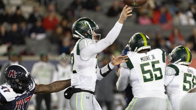 Feb 18, 2023; Houston, TX, USA; Orlando Guardian quarterback Quinten Dormady (12) throws a pass against Houston Roughnecks linebacker Chaucey Rivers (47) in the fourth quarter at TDECU Stadium. Mandatory Credit: Thomas Shea-USA TODAY Sports  
